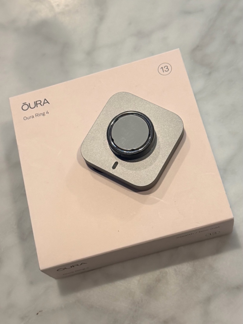Oura Stealth Charging Dock on Blush Pink Box